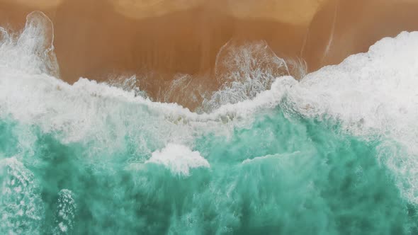 Aerial View of Immense Turquoise Ocean Waves Washing Beach