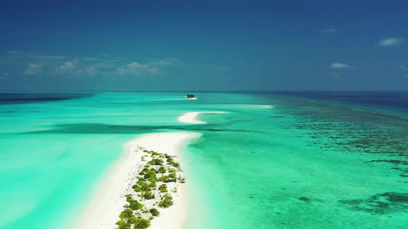 Wide above copy space shot of a paradise sunny white sand beach and blue sea background