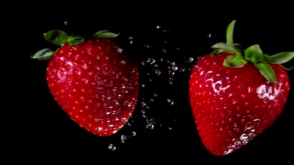 Strawberries Collide and Rotate on Black Background