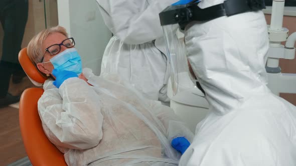 Doctor with Coverall Listening Patient Dental Problem