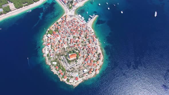 Flying above traditional dalmatian houses on Primosten peninsula, Croatia