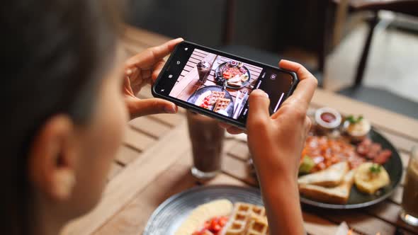 Young Woman Taking Photo of Healthy Breakfast Using Mobile Phone in Vegan Restaurant, Slowmotion