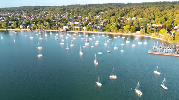 Boats tied up at lake. Sailboats anchor in harbor. Aerial view flying drone of town Herrsching at Am