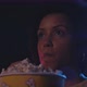 Young  woman watching a movie at the cinema and eating popcorn, entertainment concept - VideoHive Item for Sale