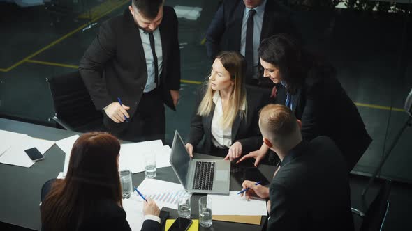 Top Managers Discussing Business Progress at Meeting