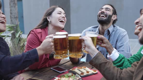 Group of Hipster Friends Enjoying Drink at Bar Terrace