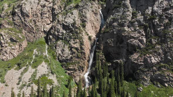 Burkhan Bulak Waterfall in the Mountains in Central Asia