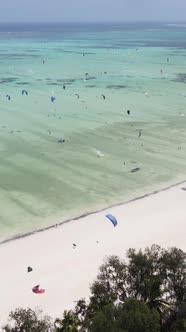 Vertical Video Kitesurfing Near the Shore of Zanzibar Tanzania