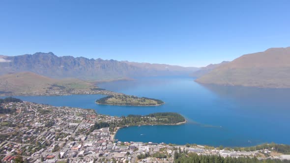 Wide panning shot of Queentstown and Lake Wakatipu with the mountains in the background, Queenstown,
