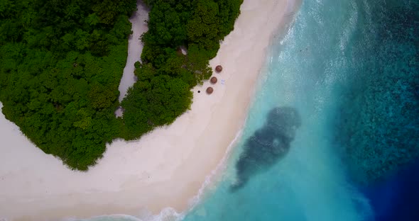 Daytime drone clean view of a sunshine white sandy paradise beach and turquoise sea background in hi