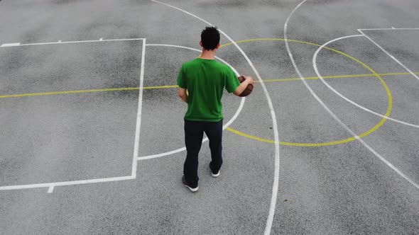 Streetball player attacking the rim, aerial slow motion