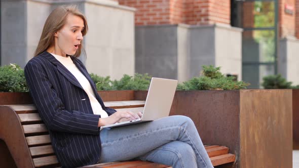 Shocked Excited Business Woman Using Laptop Sitting Outside Office