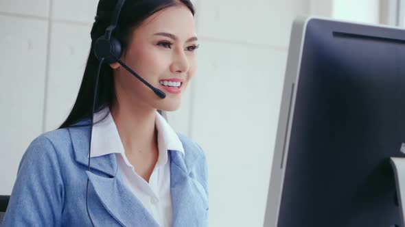 Customer Support Agent or Call Center with Headset Talking to Customer on Phone