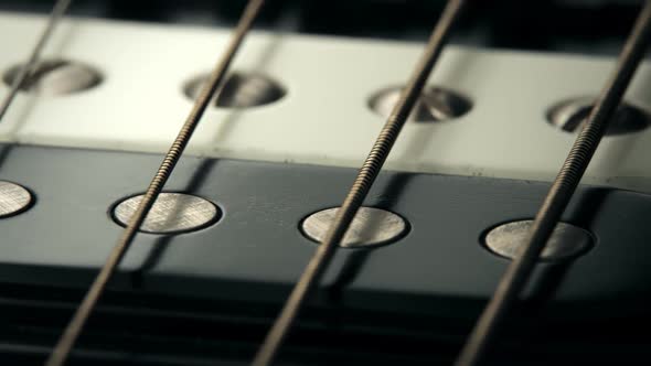 Six-string electric guitar pickup details. Worn out, rusty strings closeup. 4KHD