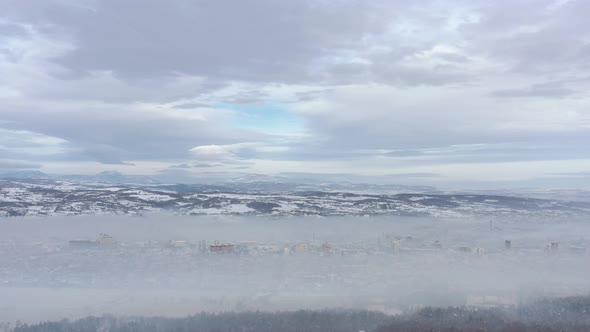 Smog over the city in the valley 4K drone video