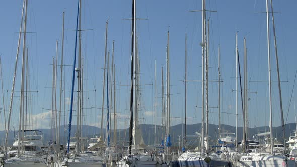 Tilt up of sailboats and masts in a port 