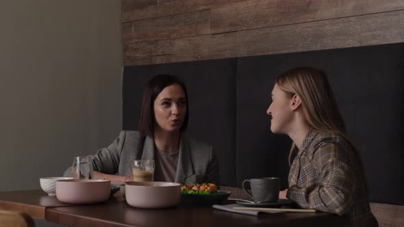 Two Girlfriends Have Lunch in a Japanese Cafe