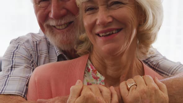 Senior couple in social distancing smiling at camera