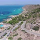 Drone flight at midday sun over Palma de Mallorca following car on coast street - VideoHive Item for Sale