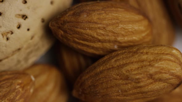 Cinematic, rotating shot of almonds on a white surface