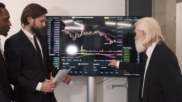 Businessmen Checking Stock Market on Digital Board