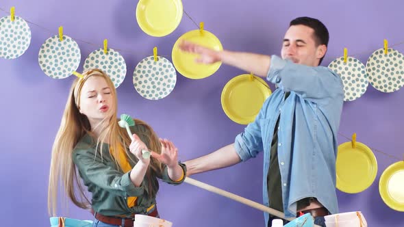 Two Young People Enjoying Singing in Kitchen