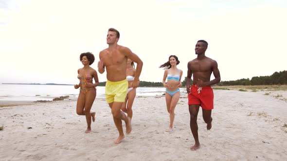 Happy Friends Running on Summer Beach 
