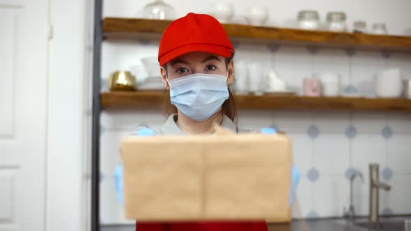 Portrait Woman Delivery Worker in Uniform Medical Face Mask Protective Gloves Carry Cardboard Box