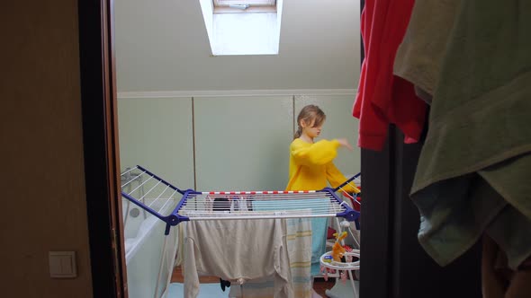 Girl Folds Dry Clothes