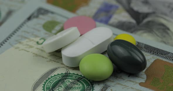 Medical Pills and Tablets on Dollar Banknote. Pharmaceutical Business Concept