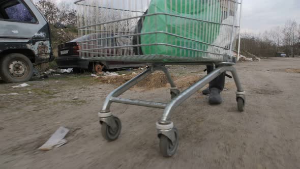  Male Pushing Cart at Garbage Dump