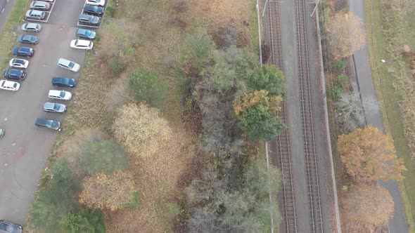 Cars Parked at Long Term Park Next to Railroad Commuter Concept Aerial