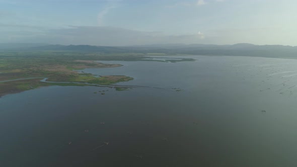 Landscape with a Lake, Farm Lands and Mountains