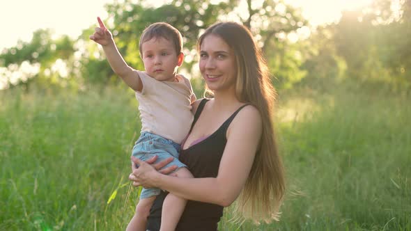 Kid and Mother are Walking in Garden