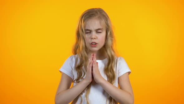 Cute Schoolgirl Praying, Asking for Dearest Wish Come True, Anxious Before Exam