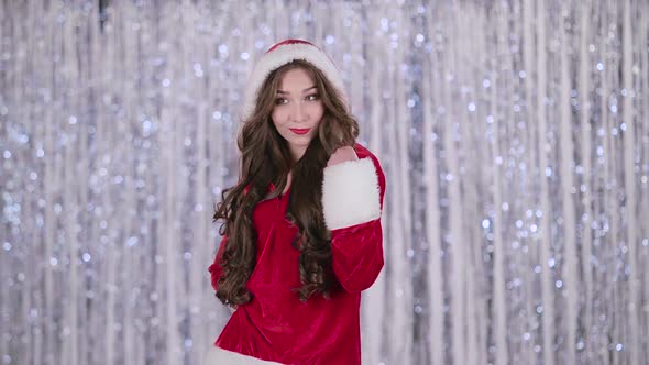 Santa Claus Girl Posing for Cameras. Bokeh Background