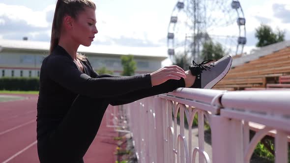 Graceful Slim Woman Warming Up at City Stadium