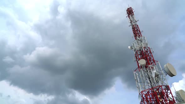 Large Telecommunication Tower Against Sky and Clouds in Background