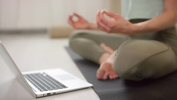 Unrecognizable Woman Meditating on Yoga Mat