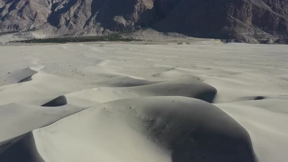aerial drone circling left in the sand dunes of the Cold Desert in Skardu Pakistan with the rocky de
