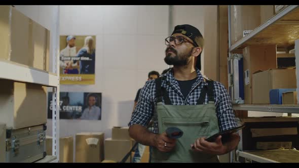 Workers Checking Packages in Warehouse