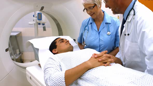 Doctor interacting with male patient before mri scan