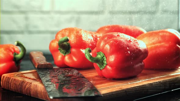 Drops of Water Fall on the Sweet Pepper with a Knife