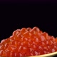Red caviar in golden spoon on black background. 4K UHD video - VideoHive Item for Sale