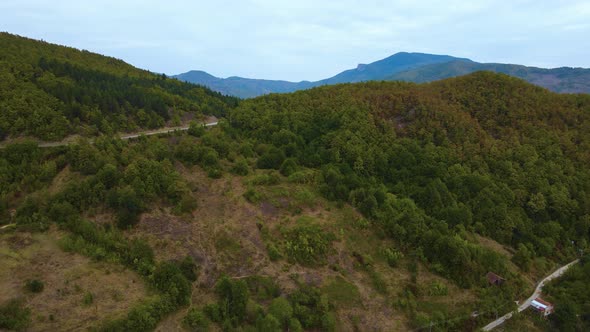 steep green mountains, deep forest and mountain road, beautiful valley  