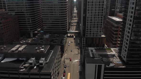 aerial footage camera tilting down at downtown Minneapolis, cars going by, sunny afternoon