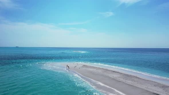 Wide angle drone copy space shot of a white paradise beach and aqua blue ocean background in colourf