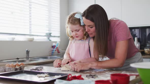 Caucasian mother and daughter having fun cooking together