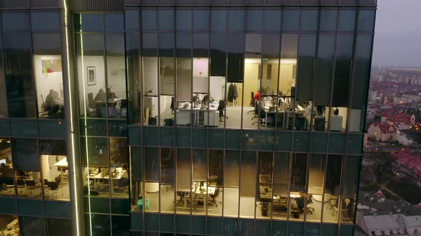 Aerial View of a Skyscraper in the Late Evening with People Working Late