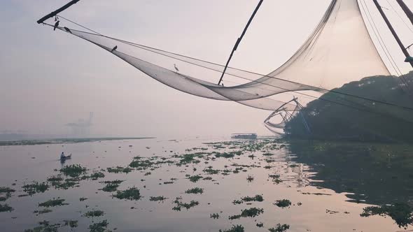 Traditional Chinese fishing nets at sunrise, Fort Kochi, India. Low aerial drone